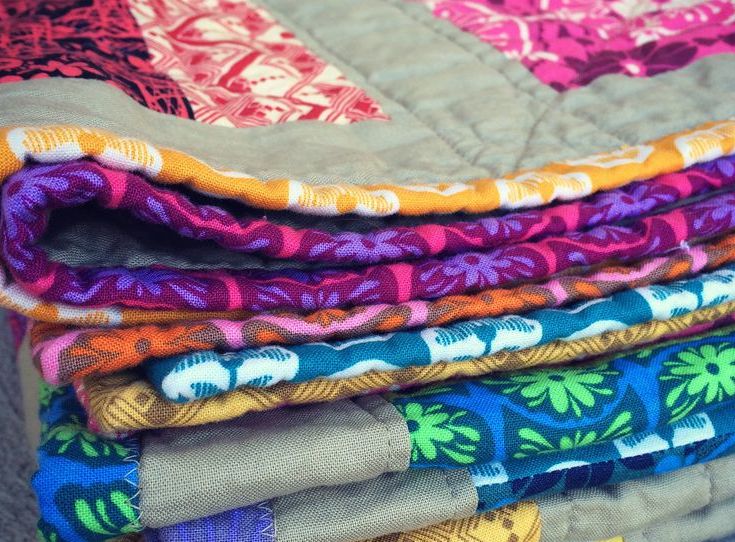 Quilts collected by Craft Hope to send to the charity We Are Kenya. 