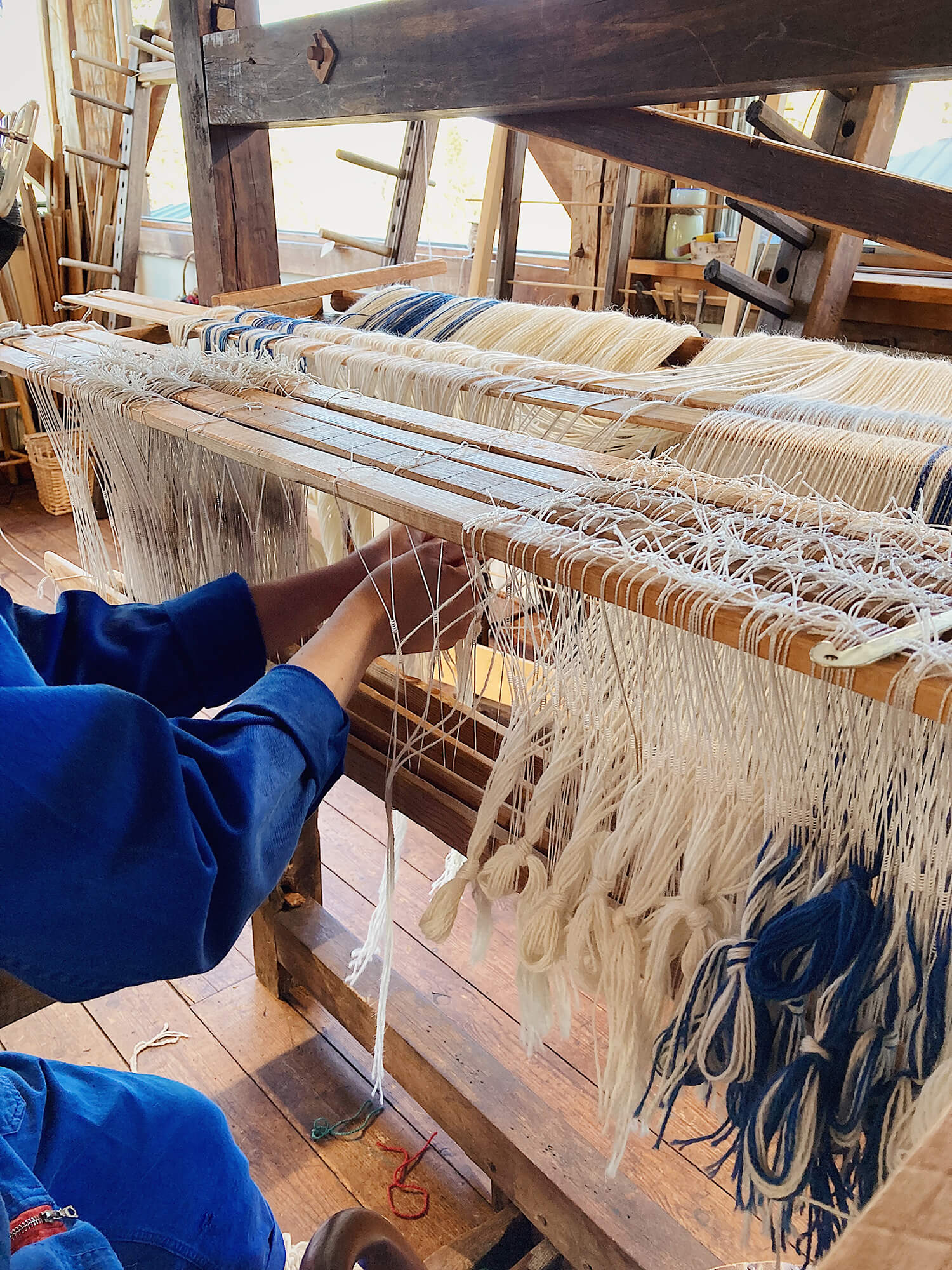 Yarn thread lines on the weaving loom machine. A loom machine for